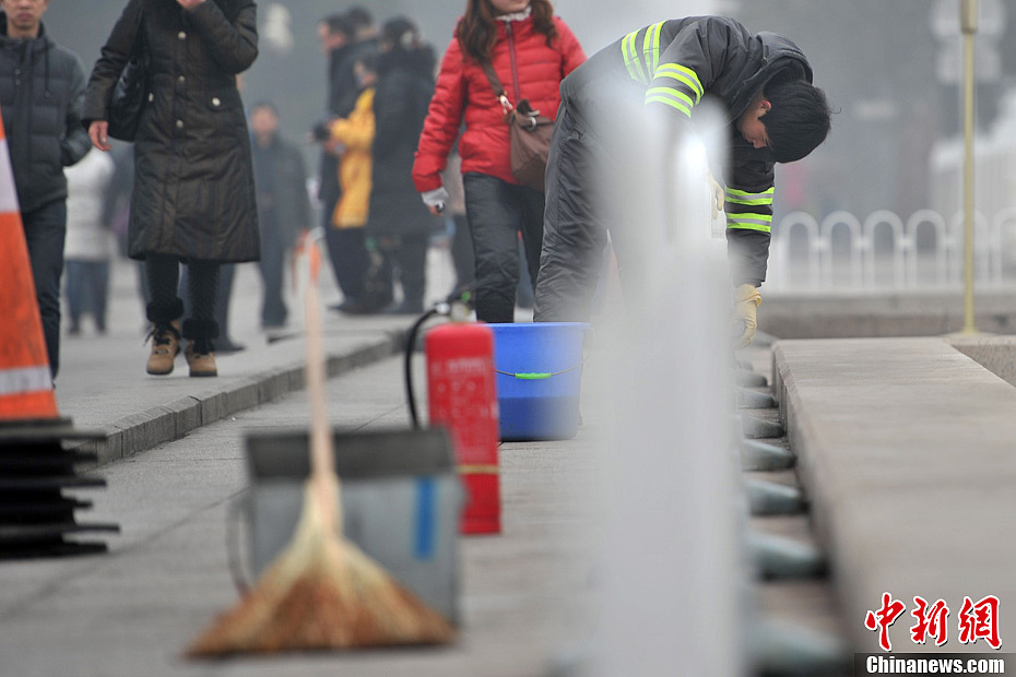 A photo taken on Jan. 29 shows a sanitation worker cleaning the smog-shrouded street. The fourth round of heavy smog in four weeks hit Beijing on Tuesday and led to serious air pollution, which has sent more people with respiratory illnesses to hospitals. However, a group of people had to stay on jobs outdoors. (Chinanews.com/Jin Shuo)