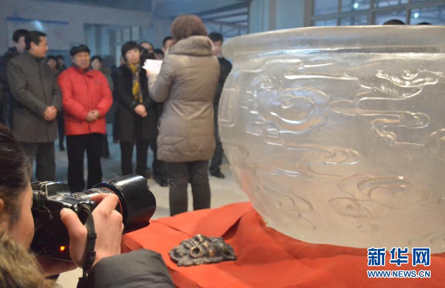 A photographer takes a photo of the largest glass bowl in the world in Qinhuangdao, north China's Hebei province on Jan. 29, 2013. (Xinhua/Cui Lisheng)