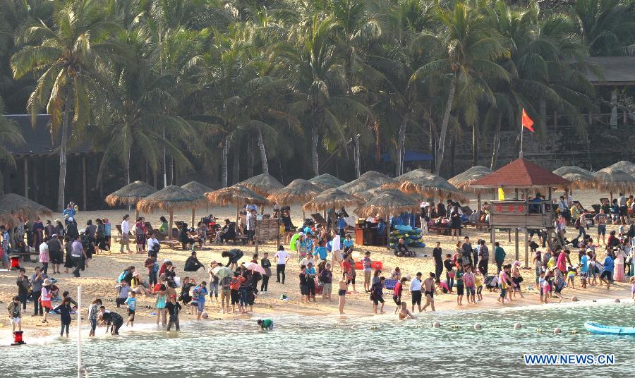Tourists enjoy themselves at the Boundary Island scenic area in Lingshui Yi Autonomous County in south China's Hainan Province, Jan. 30, 2013. Hainan launched tourism promotion with the theme of fresh air, to attract visitors from northern China where heavy haze lingered recently. (Xinhua/Zhao Yingquan) 