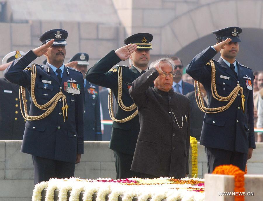 Indian President Pranab Mukherjee (C, front) salutes as he offers tributes at the memorial of Mahatma Gandhi on his death anniversary in New Delhi, India, Jan. 30, 2013. India Wednesday paid homage to Mahatma Gandhi, who led the country to independence from Britain in 1947, on his 65th death anniversary. (Xinhua/Partha Sarkar) 
