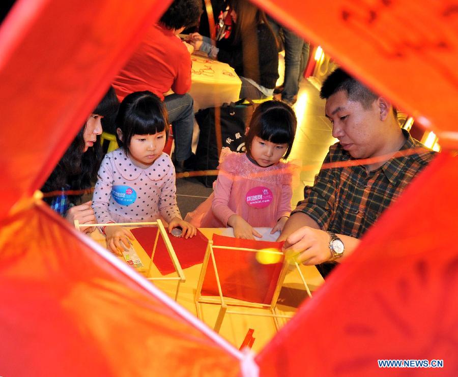 Children learn to make lanterns at a children centre in Tianjin, north China, Jan. 30, 2013. More than twenty children were invited to learn to make decorations and snacks to greet the upcoming Spring Festival which falls on Feb. 10 this year. (Xinhua/Yue Yuewei)