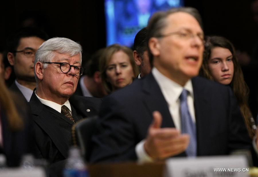 National Rifle Association (NRA) President David Keene (L) sits behind while NRA Vice President Wayne LaPierre (2ndR) answers questions during the hearing for a Senate Judiciary Committee about gun control on Capitol Hill in Washington D.C., the United States, Jan. 30, 2013. (Xinhua/Fang Zhe) 