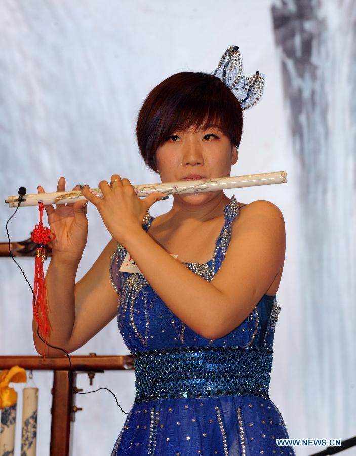 An artist plays a ceramic flute during a concert in Hong Kong, south China, Jan. 30, 2013. A band from Jingdezhen, the "porcelain capital" of China, presented a concert to the people in Hong Kong with a whole set of porcelain musical instruments. (Xinhua/Wong Pun Keung)