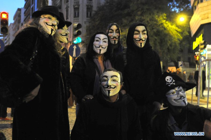 Protestors wearing masks take part in a protest in front of the Internatioanl Monetary Fund (IMF) Office in Lisbon, Portugal, on Jan, 30, 2013. Hundreds of Portuguese gathered in front of the Internatioanl Monetary Fund (IMF) Office in capital Lisbon, protesting against IMF's demand of more spending cuts by the Portuguese government and its drastic austerity policy. (Xinhua/Zhang Liyun)