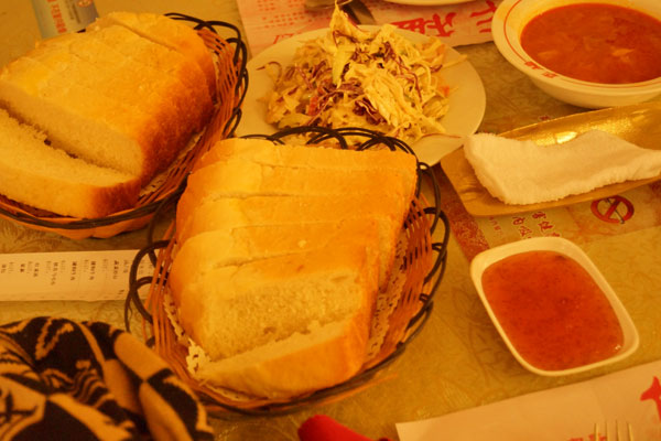 Russian bread, jam, tomato and vegetable soup, and Russian salad in a Russian-style restaurant in Harbin, northeast China's Heilongjiang Province, on December 17, 2012. [Photo: CRIENGLISH.com] 