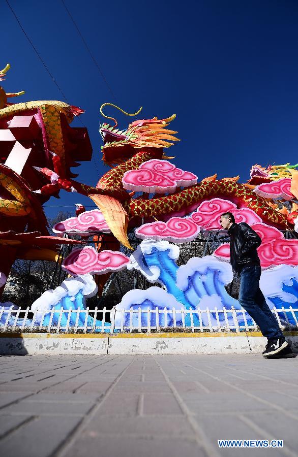 Citizens walk past a lanterns on a street in Xining, capital of northwest China's Qinghai Province, Jan. 31, 2013. Various lanterns are used here to decorate the city for the upcoming China's Lunar New Year. (Xinhua/Zhang Hongxiang)