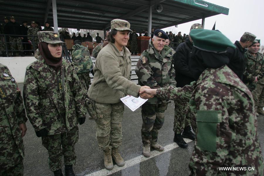 A newly graduated soldier receives her certificate during a graduation ceremony at the Kabul Military Training Center in Kabul, Afghanistan, on Jan. 31, 2013. A total of 1,400 soldiers graduated from Kabul Military Training Center (KMTC) on Thursday and were commissioned to Afghan National Army (ANA), General Aminullah Patyannai commander of KMTC said. (Xinhua/Ahmad Massoud) 