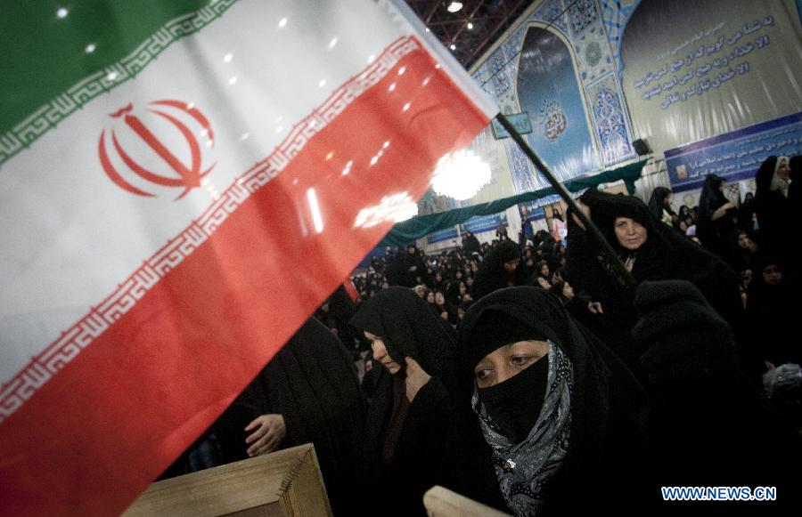 A woman waves a flag of Iran during a ceremony marking the time when Iran's late Islamic revolution leader Ayatollah Khomeini returned to Tehran, on Jan. 31, 1979 from 14 years of exile in his shrine in Tehran, Iran, Jan. 31, 2013. Iran started Thursday to celebrate the 34th anniversary of the 1979 Islamic revolution. (Xinhua/Ahmad Halabisaz)