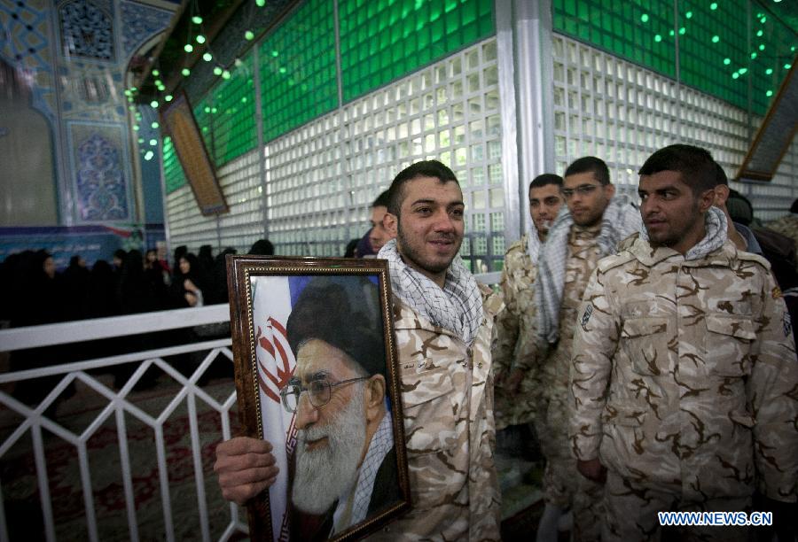 An Iranian soldier holds a picture of Iran's Supreme Leader Ayatollah Ali Khamenei in Iran's late Islamic revolution leader Ayatollah Khomeini' shrine in Tehran, Iran, Jan. 31, 2013. Iran started Thursday to celebrate the 34th anniversary of the 1979 Islamic revolution. (Xinhua/Ahmad Halabisaz)
