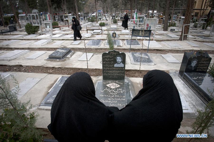 Iranian women visit the graves of people who were killed during the 1979 Islamic revolution at the Behesht-e Zahra cemetery outside Tehran, Iran, on Jan. 31, 2013, to mark the 34th anniversary of the Islamic revolution. (Xinhua/Ahmad Halabisaz) 