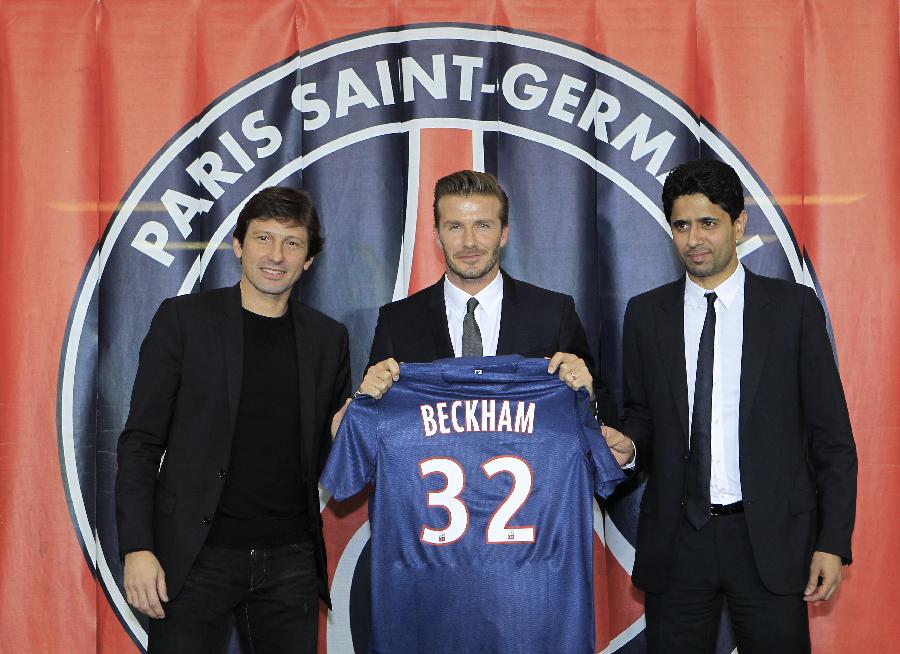Soccer player David Beckham (C) presents his new jersey after a news conference in Paris January 31, 2013. Former England captain Beckham has joined Paris St Germain on a five-month contract, the French Ligue 1 club said on Thursday. Posing with Beckham are Nasser Al-Khelaifi (R), Paris St Germain's club owner and owner of Qatari TV channel Al Jazeera Sport, President of beIN Sport French TV channel, and at Paris St-Germain sports director Leonardo (L). ( Photo: Xinhua/Reuters)