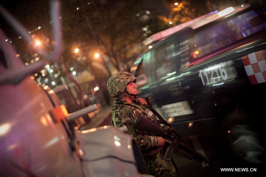 A soldier guards the headquarters of Mexico's oil giant PEMEX after an explosion occured in Mexico City, capital of Mexico, on Jan. 31, 2013. A powerful blast ripped through the landmark headquarters of Mexico's oil giant PEMEX in Mexico City on Thursday, killing 14 person, injuring more than 80 others and causing extensive damage to the building, according to local press.(Xinhua/Pedro Mera) 