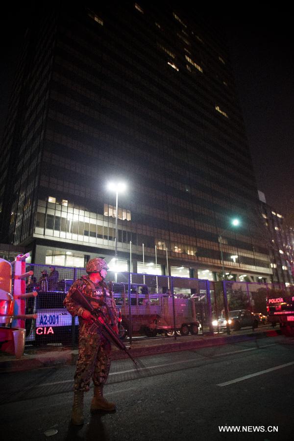 A soldier guards the headquarters of Mexico's oil giant PEMEX after an explosion in Mexico City, capital of Mexico, on Jan. 31, 2013. A powerful blast ripped through the landmark headquarters of Mexico's oil giant PEMEX in Mexico City on Thursday, killing 14 person, injuring more than 80 others and causing extensive damage to the building, according to local press.(Xinhua/Pedro Mera)