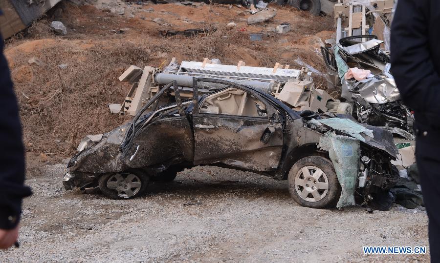 Photo taken on Feb. 1, 2013 shows a fallen car at the accident locale where an 80 meter-long section of an expressway bridge collapsed due to a truck explosion in Mianchi County of Sanmenxia City in central China's Henan Province.(Xinhua/Zhao Peng)