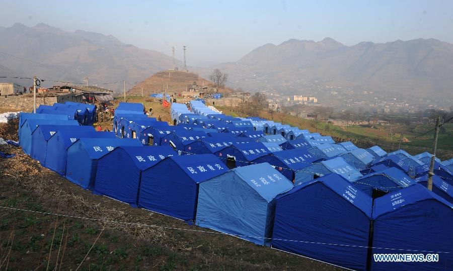 Photo taken on Feb. 1, 2013 shows the temporary tents of affected people at Zhongtun Township in Zhenxiong County, southwest China's Yunnan Province. A landslide destroyed 35 houses, damaged 928 others and affected the lives of 712 people here. All villagers who were affected by the landslide have been relocated, the county government said. No casualties have been reported. (Xinhua/Qin Qing)