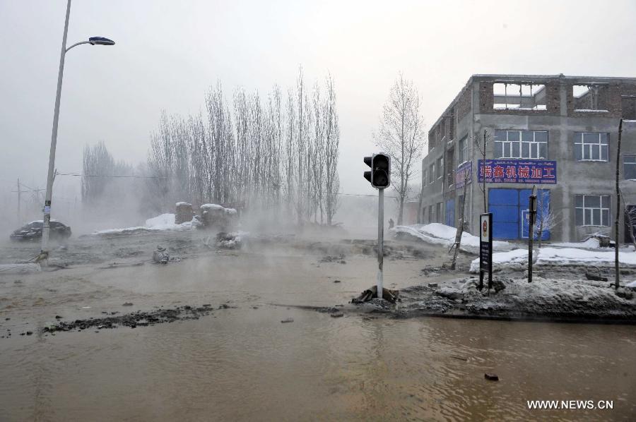 Photo taken on Feb. 2, 2013 shows the waterlogged road after a dyke breaching accident of the Lianfeng Reservoir occured in Urumqi, capital of northwest China's Xinjiang Uygur Autonomous Region. At least one person was killed and serveral injured after a dyke breaching occured at the reservior on the morning of Saturday. The rescue work is underway. (Xinhua/Zhao Ge) 
