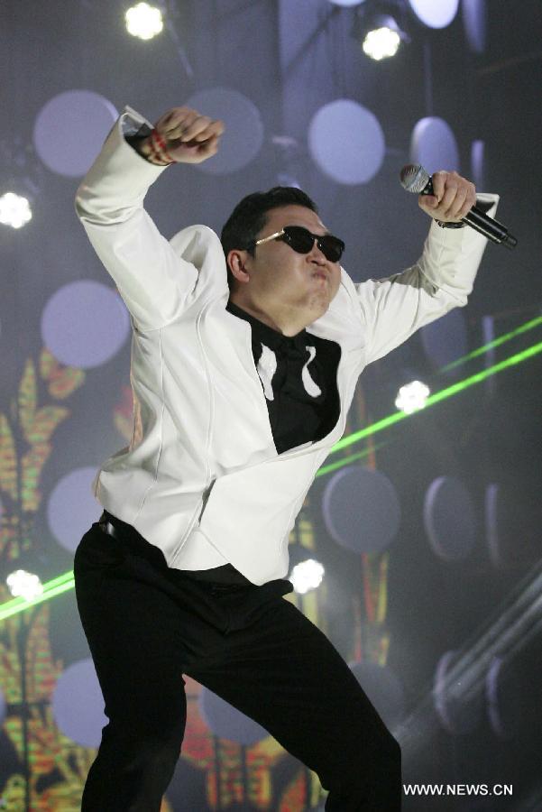 South Korean singer Psy dances as he sings his hit single "Gangnam Style" during a concert at Nanjing Olympic Sports Center in Nanjing, capital of east China's Jiangsu Province, Feb. 2, 2013. It is the first time for Psy to participate in commercial performance on the Chinese mainland. (Xinhua/Yan Minhang) 