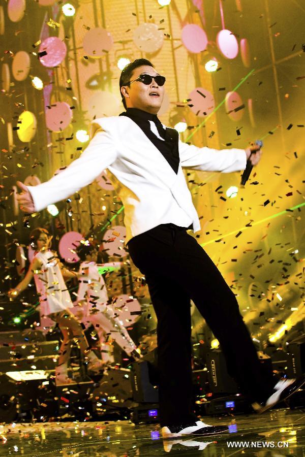 South Korean singer Psy dances as he sings his hit single "Gangnam Style" during a concert at Nanjing Olympic Sports Center in Nanjing, capital of east China's Jiangsu Province, Feb. 2, 2013. It is the first time for Psy to participate in commercial performance on the Chinese mainland. (Xinhua/Yan Minhang)