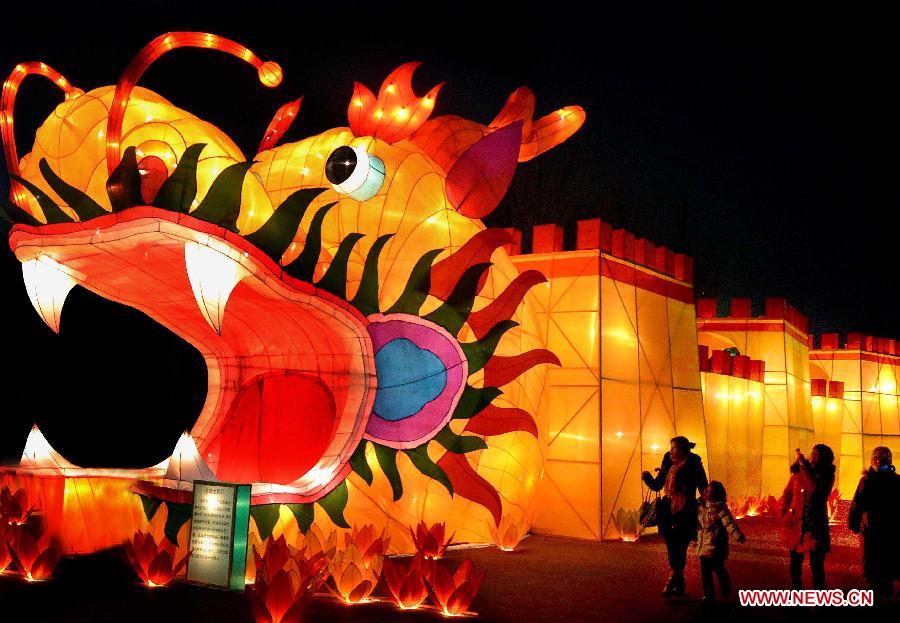 People walk past lanterns at a lantern fair in Zehngzhou, capital of central China's Henan Province, Jan. 26, 2012. Chinese people has a tradition to enjoy lanterns during the Lantern Festival which falls on the 15th day of the first lunar month. (Xinhua/Wang Song)