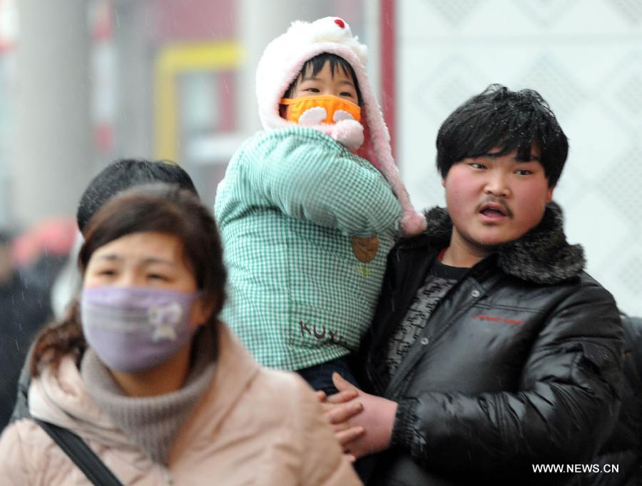 A man carries his daughter at the Beijing West Railway Station in Beijing, capital of China, Feb. 3, 2013. Many children travel with their families during the 40-day Spring Festival travel rush which started on Jan. 26. (Xinhua/Chen Shugen)
