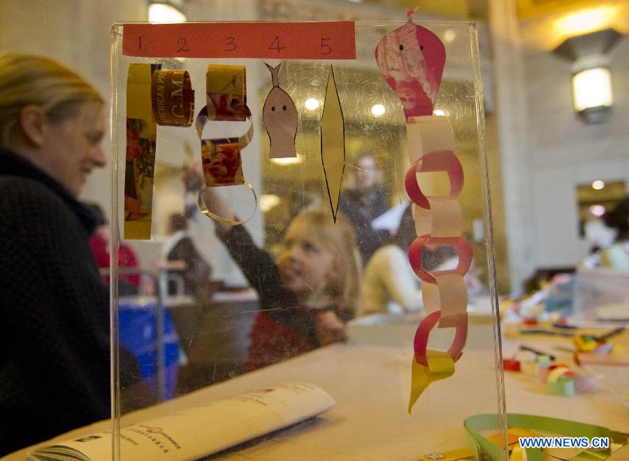 A girl learns to make a paper snake during the Chinese Cultural Heritage Day event at the Royal Ontario Museum in Toronto, Canada, Feb. 2, 2013. One of the most prominent museums in the Canadian city of Toronto was transformed into a galore of Chinese artistry on Saturday, presenting a live snake display, an ethnic costume display and a diverse array of Chinese-themed performances. (Xinhua/Zou Zheng)