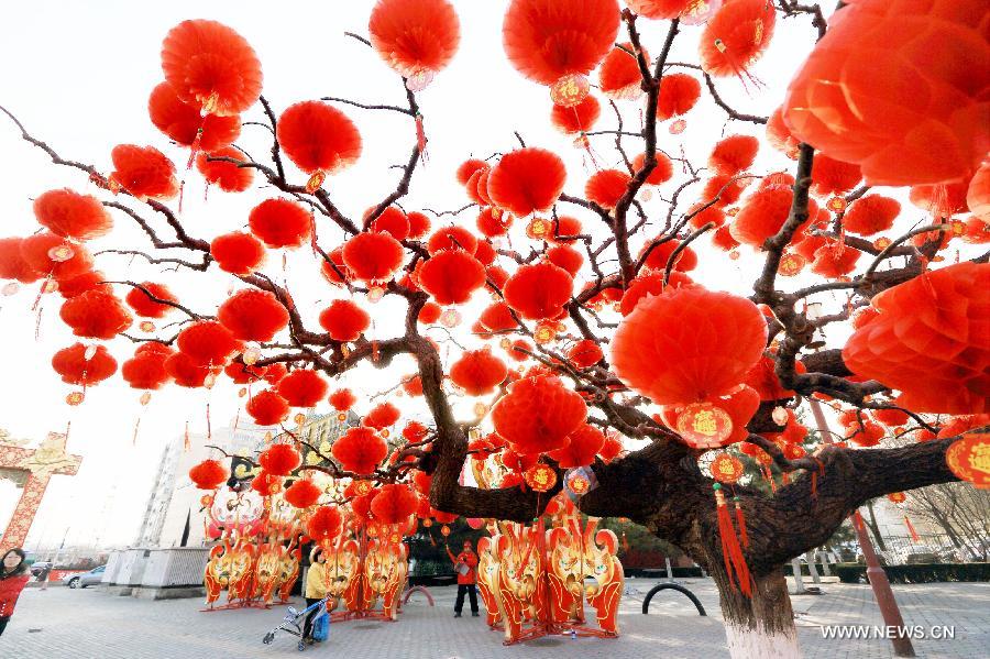 Red lanterns are hanged on trees in the Temple of Earth Park in Beijing, capital of China, Feb. 2, 2013. The Temple of Earth Park was decorated with red lanterns so as to celebrate the upcoming Spring Festival or Chinese Lunar New Year. (Xinhua)