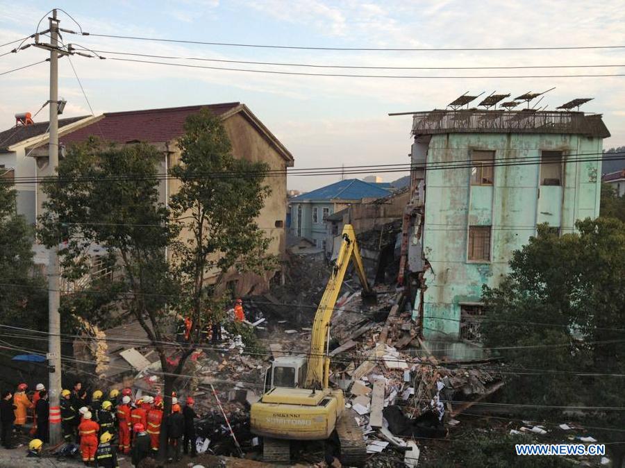 Rescuers search for victims in the debris at the accident site of a suspected boiler explosion in Cixi, east China's Zhejiang Province, Feb. 3, 2013. Two people were killed and six others injured Sunday morning when a three-story building of a flour products plant collapsed in Cixi's Shishan Village. Investigation into the exact cause of the incident is under way. (Xinhua/Liu Huiming) 