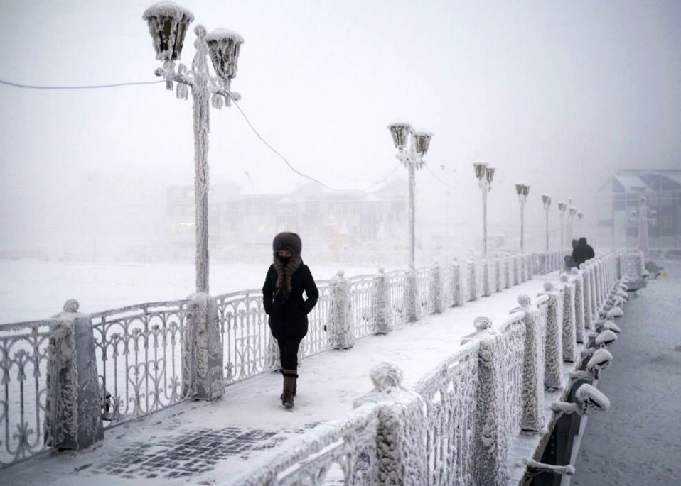A woman walks over an ice-encrusted bridge in Yakutsk Village of Oymyakon, which is considered to be the coldest permanently inhabited settlement in the world. (Globaltimes.cn)