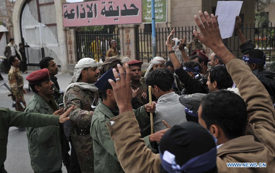 Protestors clash with soldiers during a demonstration requiring the government to provide medical treatment to protestors who were wounded during the 2011 uprising in Sanaa, Yemen, on Feb. 3, 2013. (Xinhua/Mohammed Mohammed)