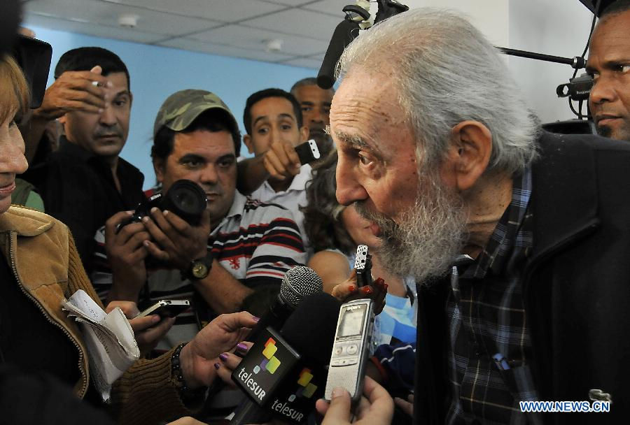 Cuban former leader Fidel Castro (R) receives interview after casting his vote during the second phase of the general elections from 2012 to 2013, at the Revolution Square in Havana, capital of Cuba, on Feb. 3, 2013. (Xinhua/Joaquin Hernandez)