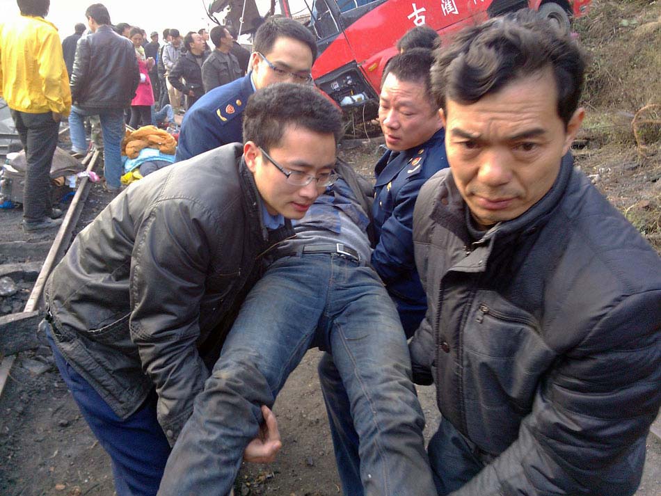 A photo taken on Feb.1 shows rescuers transporting a man injured in a turnover accident in Sichuan province. A coach flipped over into a 100-meter-deep roadside slope and 11 onboard were killed. Road accidents have claimed about 60 lives from Jan. 31 to Feb. 1. The fatal accidents shocked the whole country as hundreds of millions of Chinese journeyed home amid the Spring Festival travel rush that started on Jan. 26. (Photo/Xinhua)