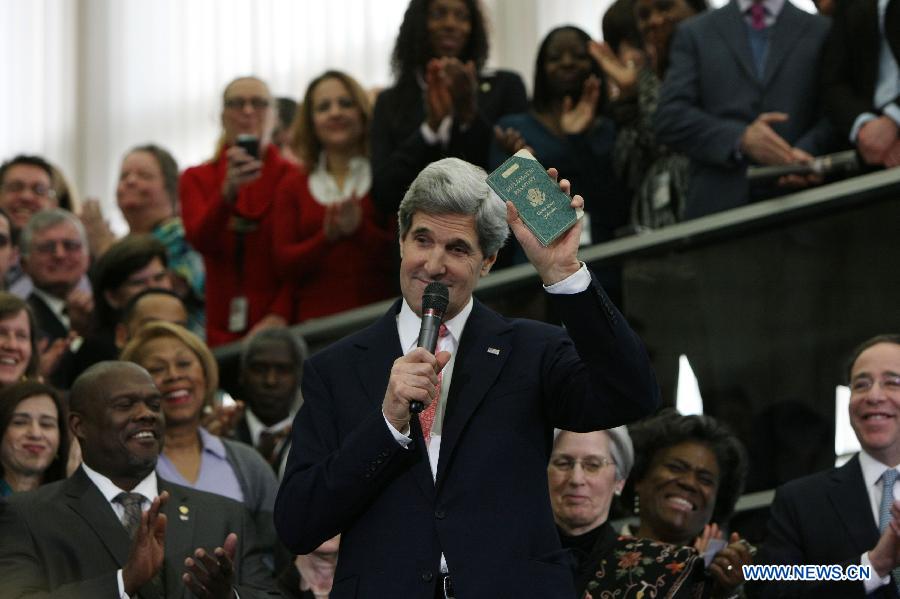 U.S. Secretary of State John Kerry shows his first diplomatic passport during the welcoming ceremony at the Department of State in Washington D.C. on Feb.4, 2013. John Kerry was sworn in on Friday to succeed Hillary Clinton to become U.S. Secretary of State. (Xinhua/Fang Zhe) 