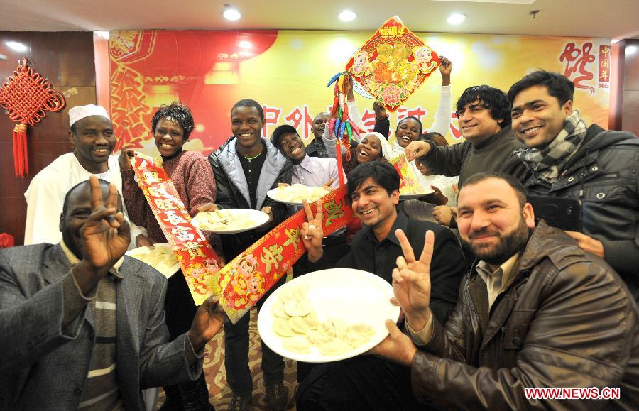 Overseas students present dumplings they made in an activity to celebrate the Chinese New Year at the Nanjing Agricultural University in Nanjing, capital of east China's Jiangsu Province, Feb. 4, 2013. More than 50 overseas students from over 20 countries and regions experienced Chinese traditional cultural activities with local students. (Xinhua)  