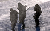 Servicemen foot patrol in snowfield