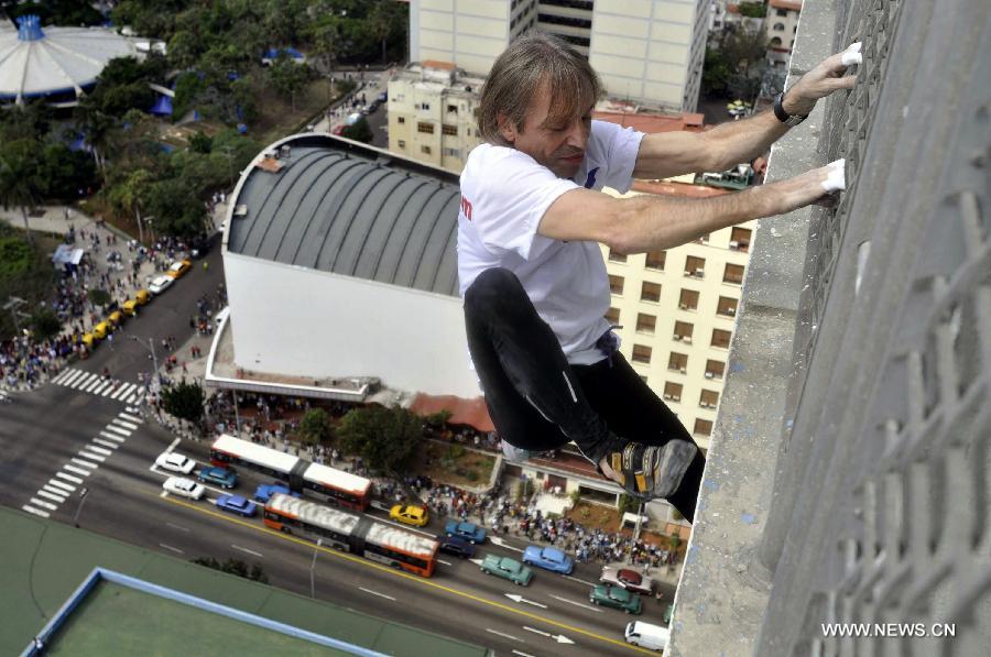 The so-called French Spiderman, Alain Robert, scales the landmark Havana Libre hotel without safety equipment in Havana, Cuba, on Feb. 4, 2013. (Xinhua/Joaquin Hernandez) 