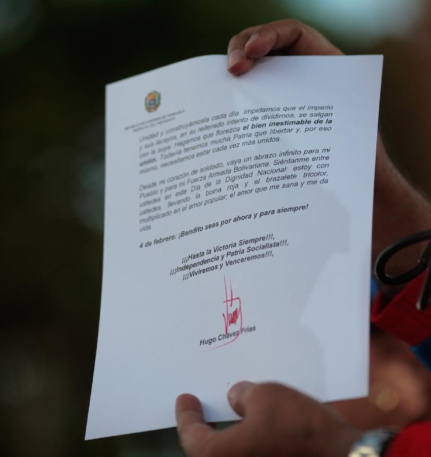Image provided by Presidency of Venezuela shows Venezuelan Vice President Nicolas Maduro showing a letter sent by Venezuelan President Hugo Chavez during a ceremony marking the 21st anniversary of a failed coup led by Venezuelan President Hugo Chavez in 1992, in Caracas, capital of Venezuela, on Feb. 4, 2013. (Xinhua/Presidency of Venezuela) 
