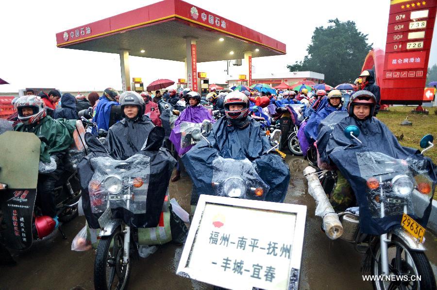 Migrant workers from east China's Jiangxi Province gather at a gas station before their homebound motorcycle journey starts in Fuzhou, capital of southeast China's Fujian Province, Feb. 5, 2013. Many migrant workers in China choose motorcycle as the means of transport when they return to their hometowns for family reunion during the Spring Festival. (Xinhua/Zhang Guojun) 