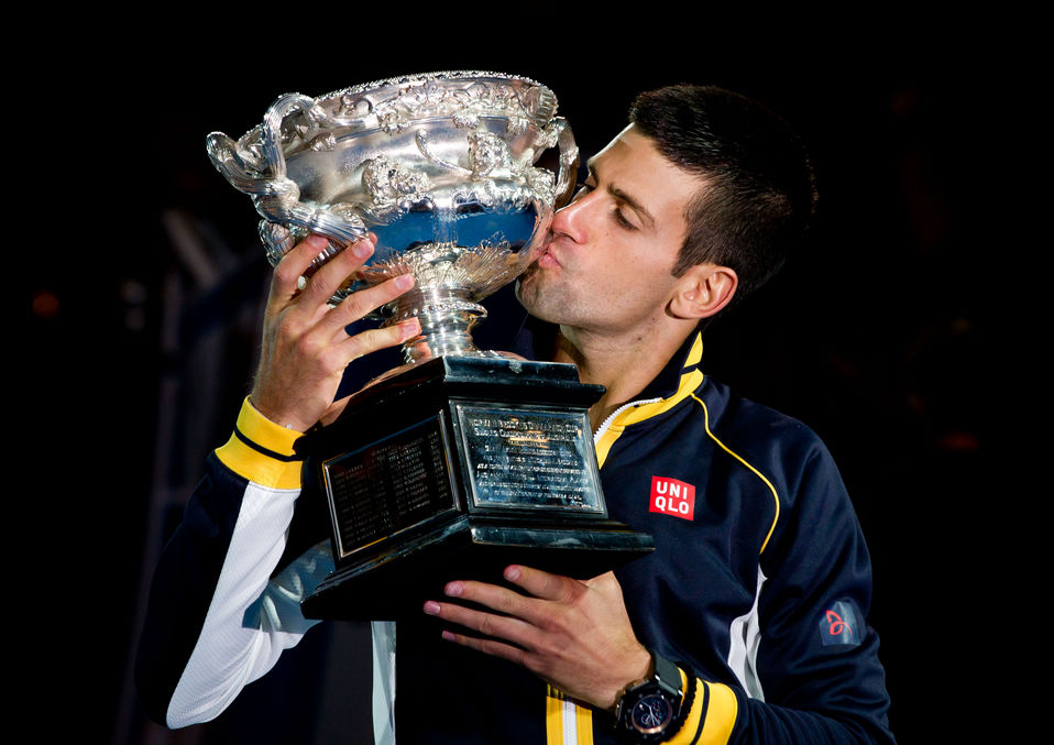 Serbia's Novak Djokovic kisses his trophy after defeating Britain's Andy Murray in the men's final at the Australian Open tennis championship in Melbourne, Australia, Jan. 28, 2013. (Xinhua/Bai Xue)