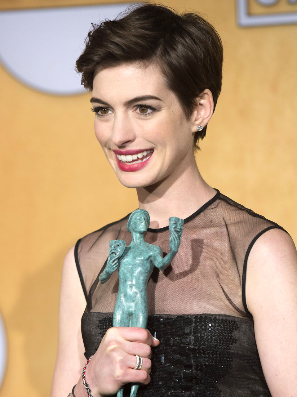 Actress Anne Hathaway accepts the award for Outstanding Performance by a Female Actor in a Supporting Role for “Les Miserables” onstage during the 19th Annual Screen Actors Guild Awards held at The Shrine Auditorium on Jan. 27, 2013 in Los Angeles, California. (Xinhua/Yang Lei)