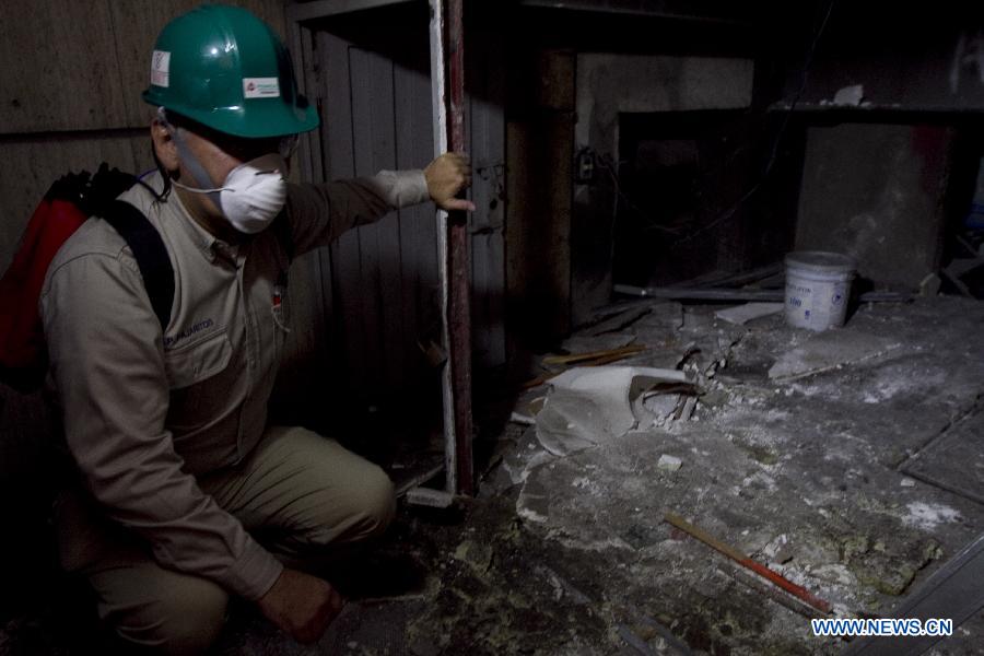 An employee begins with the clean up in the zone of the blast in the Pemex-Management B2 building in Mexico City, capital of Mexico, on Feb. 5, 2013. (Xinhua/Alejandro Ayala) 