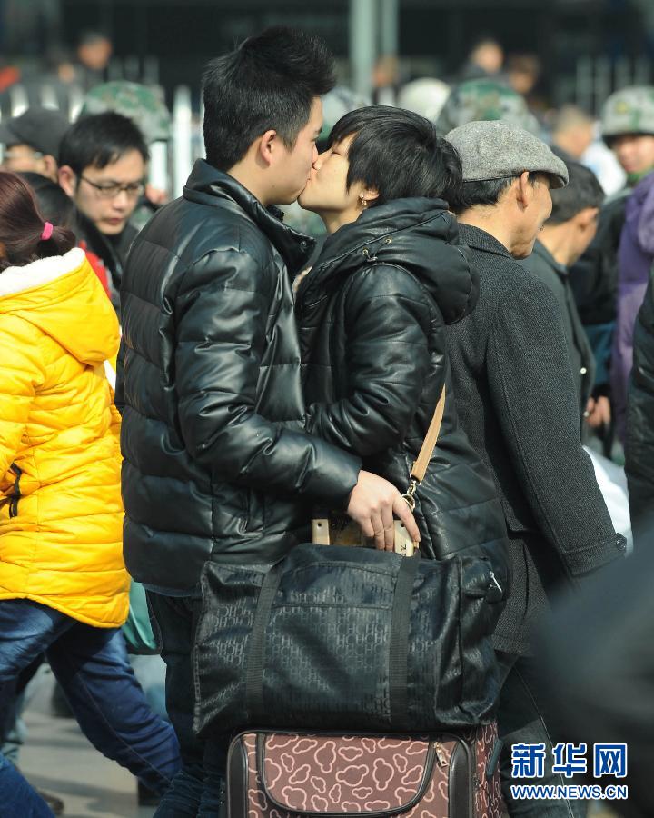 A couple kisses before seperation at the square of Chengdu Railway Station on Jan. 26, 2013. (Xinhua/Xue Yubin)