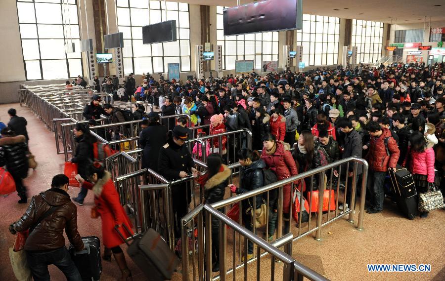 Passengers have their tickets checked at the Zhengzhou Railway Station in Zhengzhou, capital of central China's Henan Province, Feb. 6, 2013. China's transport system sees an annual travel rush around the Spring Festival, which starts on Feb. 10 this year. (Xinhua/Li Bo)