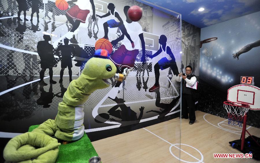 A basketball-throwing robot is displayed in a newly inaugurated robot pavilion at Taipei Expo Park in Taipei, southeast China's Taiwan, Feb. 6, 2013. The robot pavilion was inaugurated Wednesday at the Xinsheng Park of Taipei Expo Park. The facility features 60 robotic exhibits. (Xinhua/Wu Ching-teng)