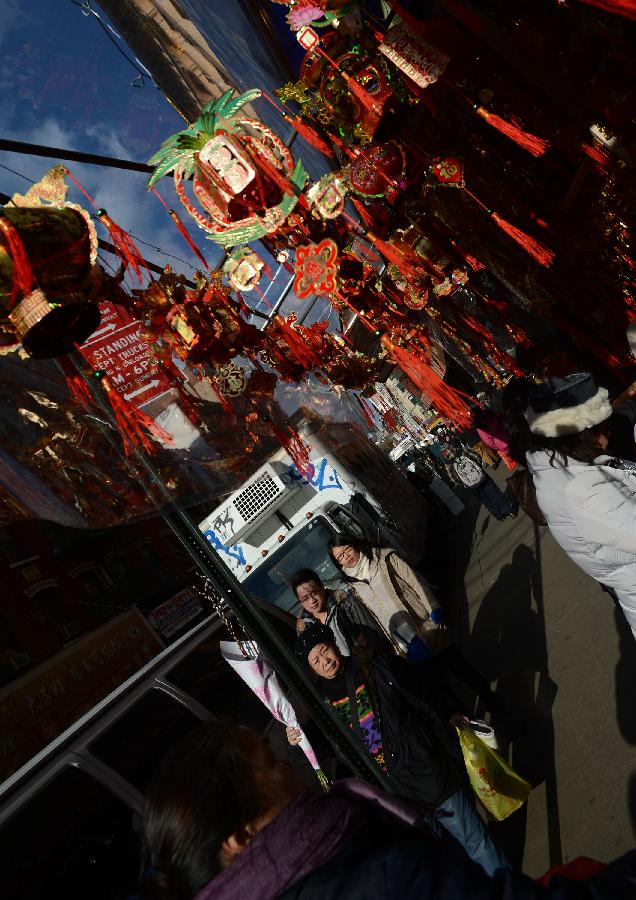 Local Chinese buy traditional decorations for the upcoming Chinese Lunar New Year in China Town, New York, the United States, Feb. 6, 2013. The Chinese Lunar New Year, or Spring Festival, starts on Feb. 10 this year. (Xinhua/Wang Lei)  