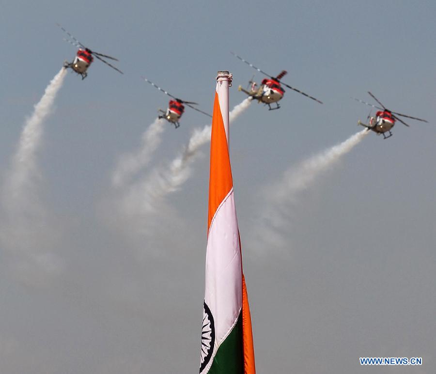 Helicopters perform during the opening of the Aero India 2013 at Yelahanka air base in Bangalore, India, Feb. 6, 2013. More than 600 aviation companies and delegations from 78 countries and regions participated in the five-day event started here on Wednesday. (Xinhua/Stringer）