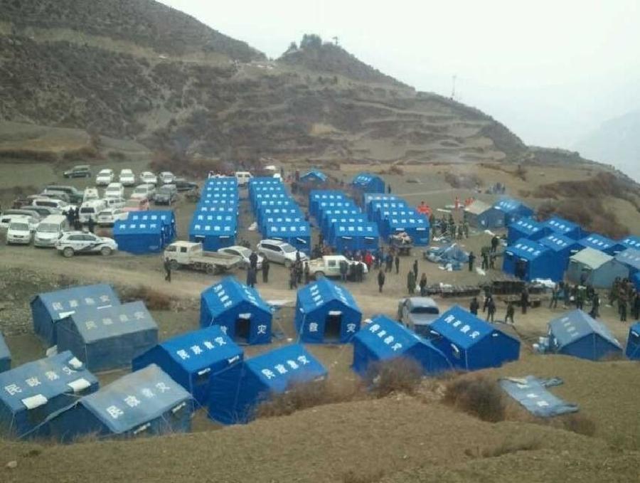 Photo taken on Feb. 7, 2013 with a cellphone shows tents set up for victims of a fire in Heiduo Village of Diebu County in northwest China's Gansu Province. The fire broke out in Heiduo Village around 8 p.m. and was put out Thursday morning, leaving destruction of 92 homes and no casualties. (Xinhua/Niu Zhien)