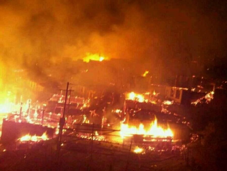 Photo taken on Feb. 6, 2013 with a cellphone shows the scene of a fire in Heiduo Village of Diebu County in northwest China's Gansu Province. The fire broke out in Heiduo Village around 8 p.m. and was put out Thursday morning, leaving destruction of 92 homes and no casualties. (Xinhua/Niu Zhien)