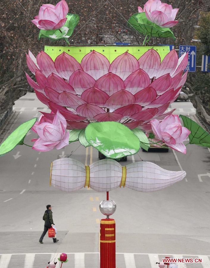 A man walks under a giant lotus lantern in Nanjing, capital of east China's Jiangsu Province, Feb. 8, 2013. The Spring Festival, the most important occasion for the family reunion for the Chinese people, falls on the first day of the first month of the traditional Chinese lunar calendar, or Feb. 10 this year. (Xinhua)