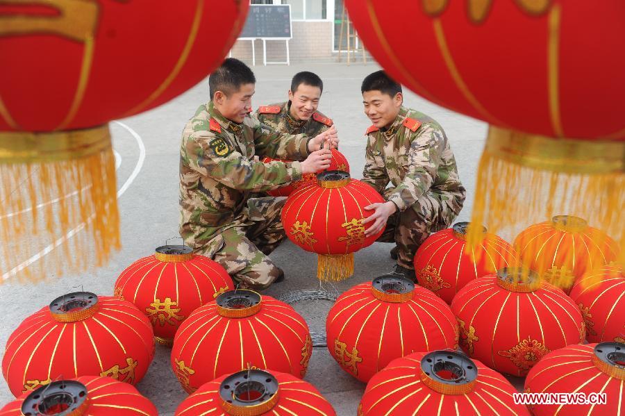 Soldiers prepare red lanterns to decorate their barrack for the coming Spring Festival in Fuyang City, east China's Anhui Province, Feb. 8, 2013. The Spring Festival, the most important occasion for the family reunion for the Chinese people, falls on the first day of the first month of the traditional Chinese lunar calendar, or Feb. 10 this year. (Xinhua/Wang Biao)