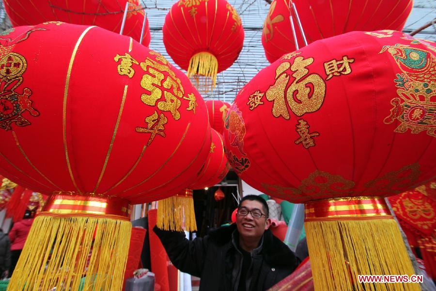 A man selects red lanterns for the coming Spring Festival in Linyi City, east China's Shandong Province, Feb. 8, 2013. The Spring Festival, the most important occasion for the family reunion for the Chinese people, falls on the first day of the first month of the traditional Chinese lunar calendar, or Feb. 10 this year. (Xinhua/Zhang Chunlei)